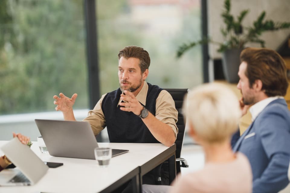 Consultants meeting with a client around a table